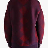 Red sweater worn by a person, showing the sweater fit
