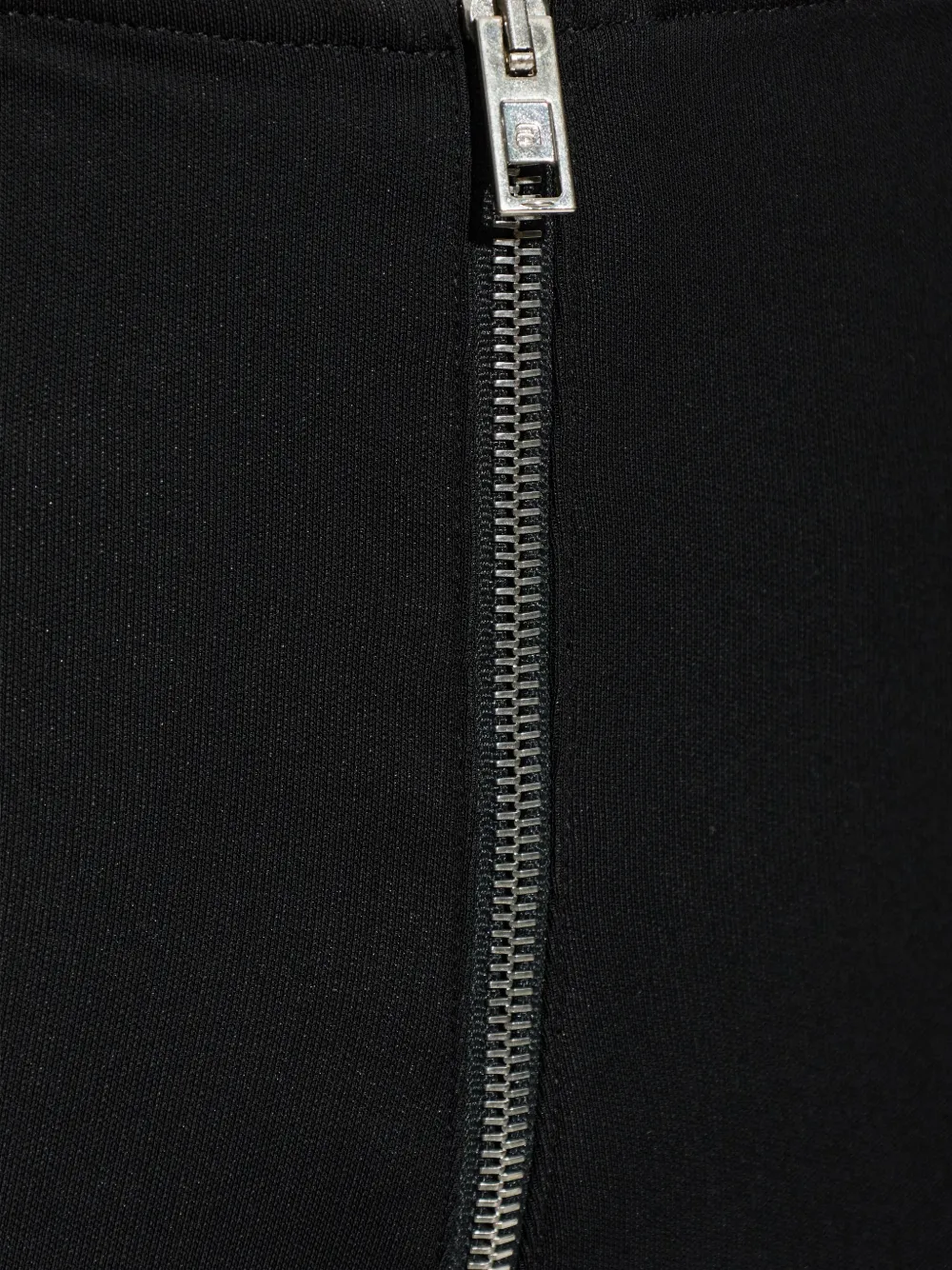 Close-up of black pants, showing texture of the viscose fabric