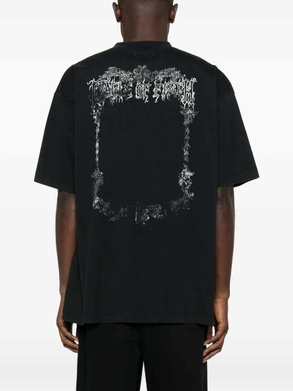 Black t-shirt worn by a person, showing the shirt's fit