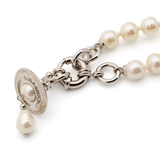 Close up of White necklace, showing texture of the pearl fabric