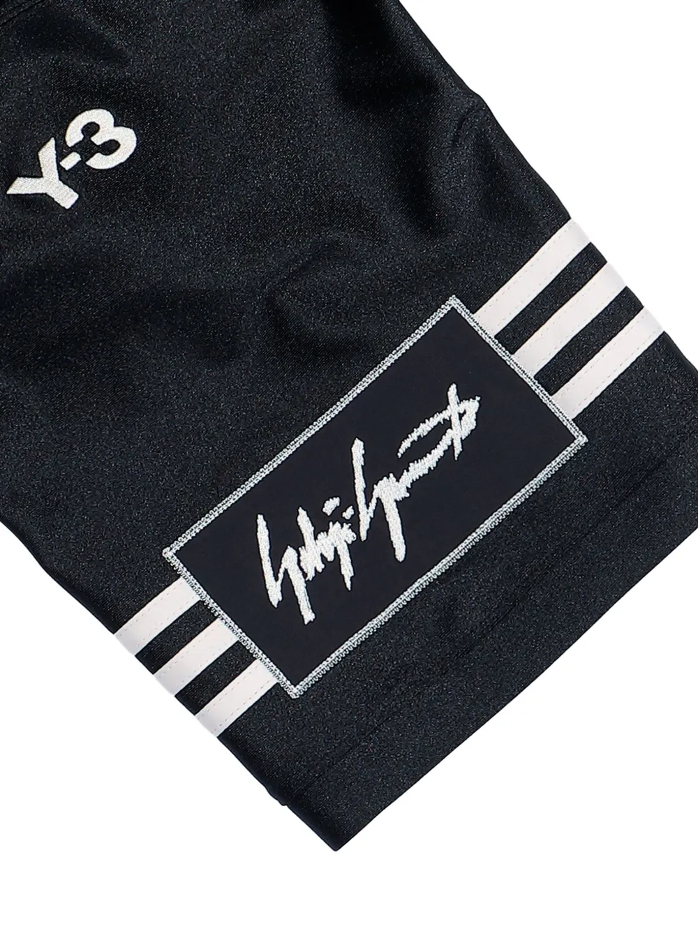 close up of black t-shirts , showing texture of the  recycled polyester fabric