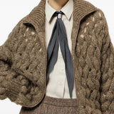 Brown knitwear worn by a person, showing the knitwear fit