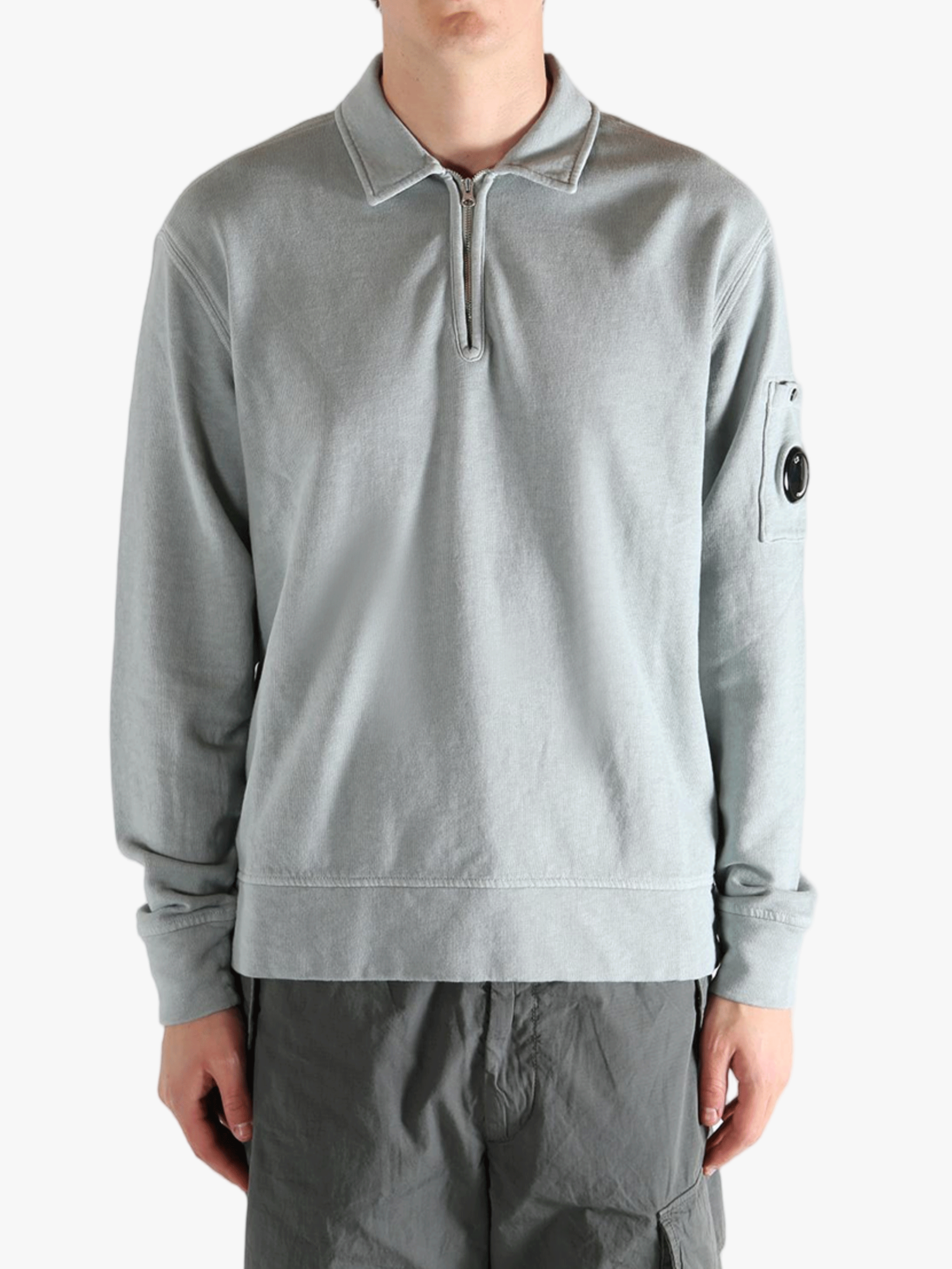 Gray long-sleeve shirt worn by a person, showing the shirt's fit