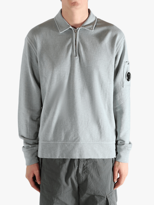 Gray long-sleeve shirt worn by a person, showing the shirt's fit