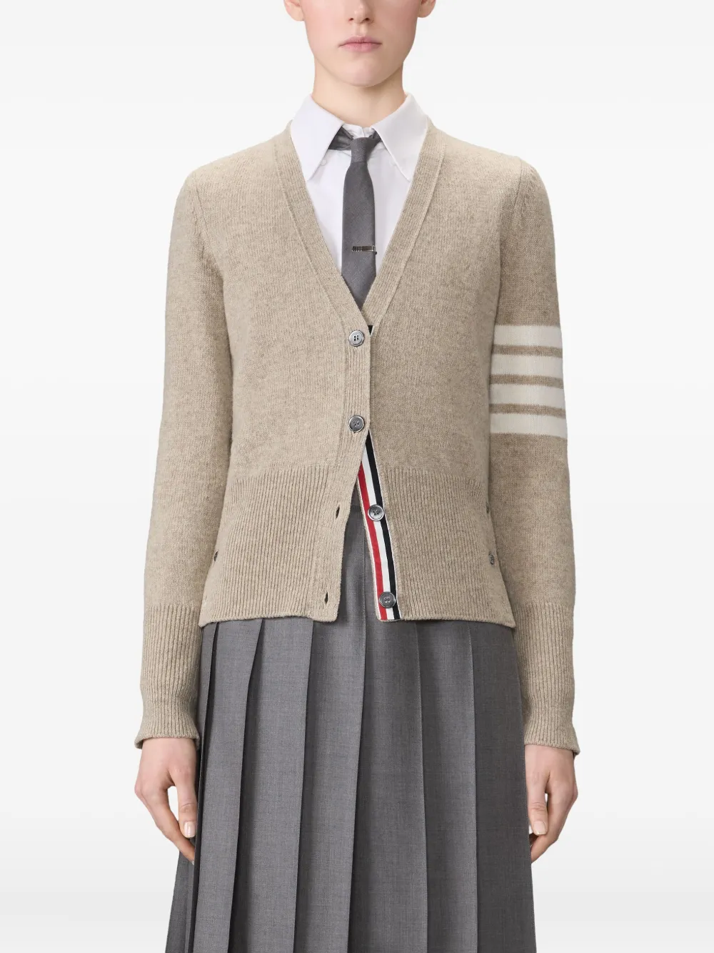 tan knitwear worn by a person, showing the knitwear fit