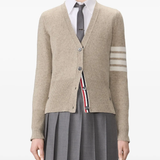 tan knitwear worn by a person, showing the knitwear fit