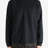 Black shirts worn by a person, showing the shirts fit