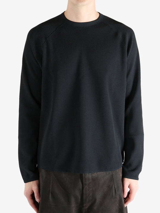 Black shirts worn by a person, showing the shirts fit