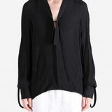 Black shirt worn by a person, showing the shirt fit