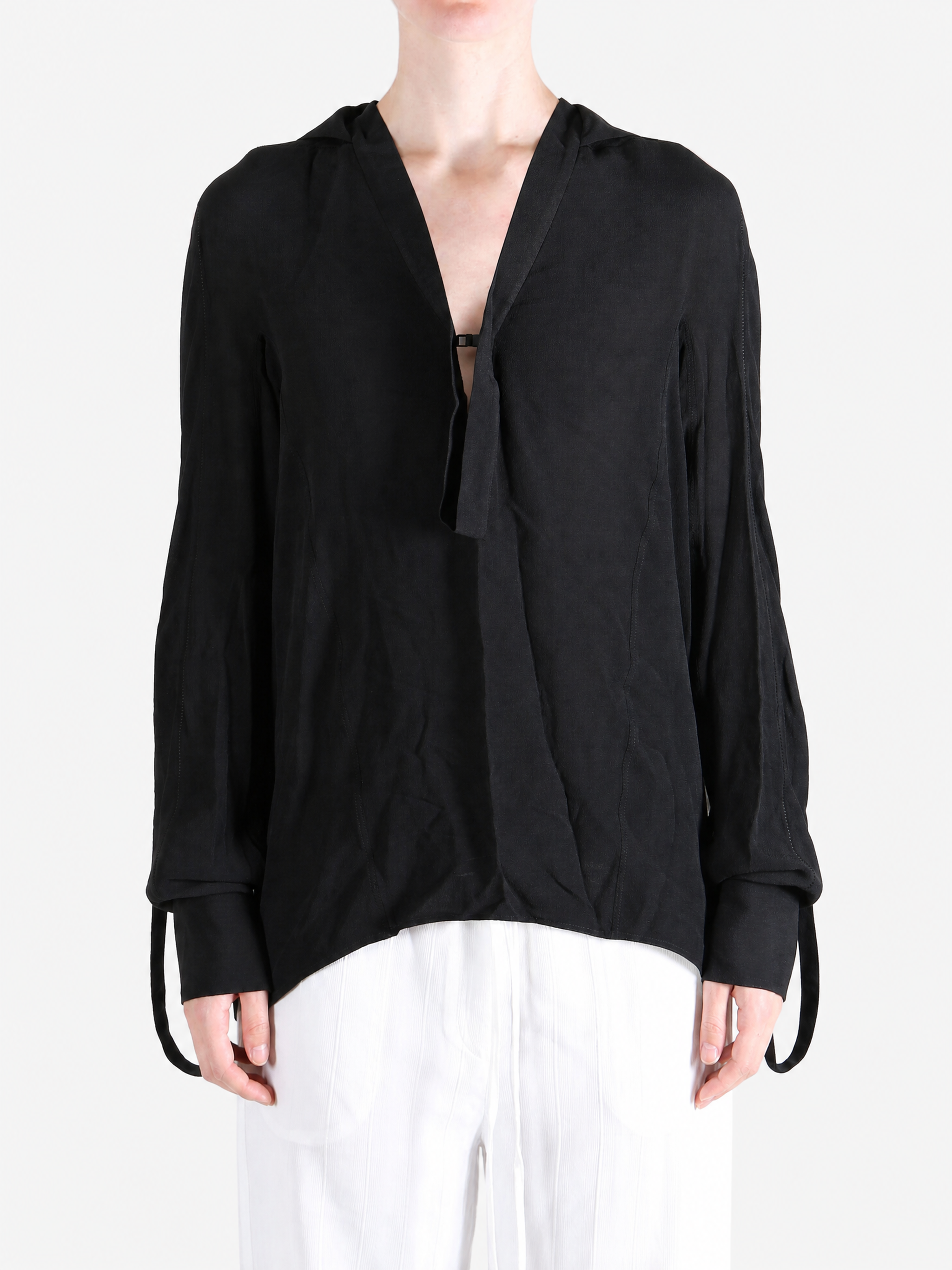 Black shirt worn by a person, showing the shirt fit