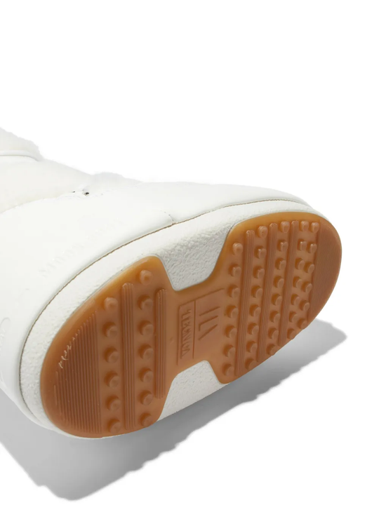 Close up of the white boot, showing texture of the rubber fabric