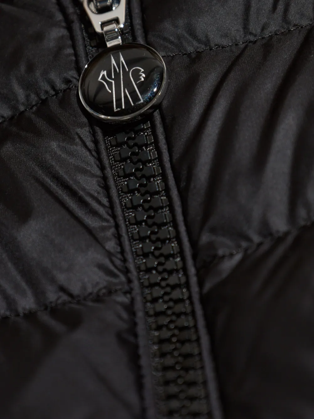 Close up of black jackets, showing texture of the nylon fabric