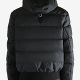 Black coat worn by a person, showing the coat's fit