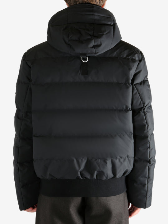 Black coat worn by a person, showing the coat's fit