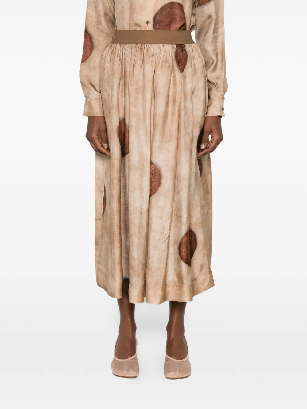 Tan skirt worn by a person, showing the skirt's fit