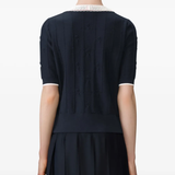 Navy top worn by a person, showing the top fit