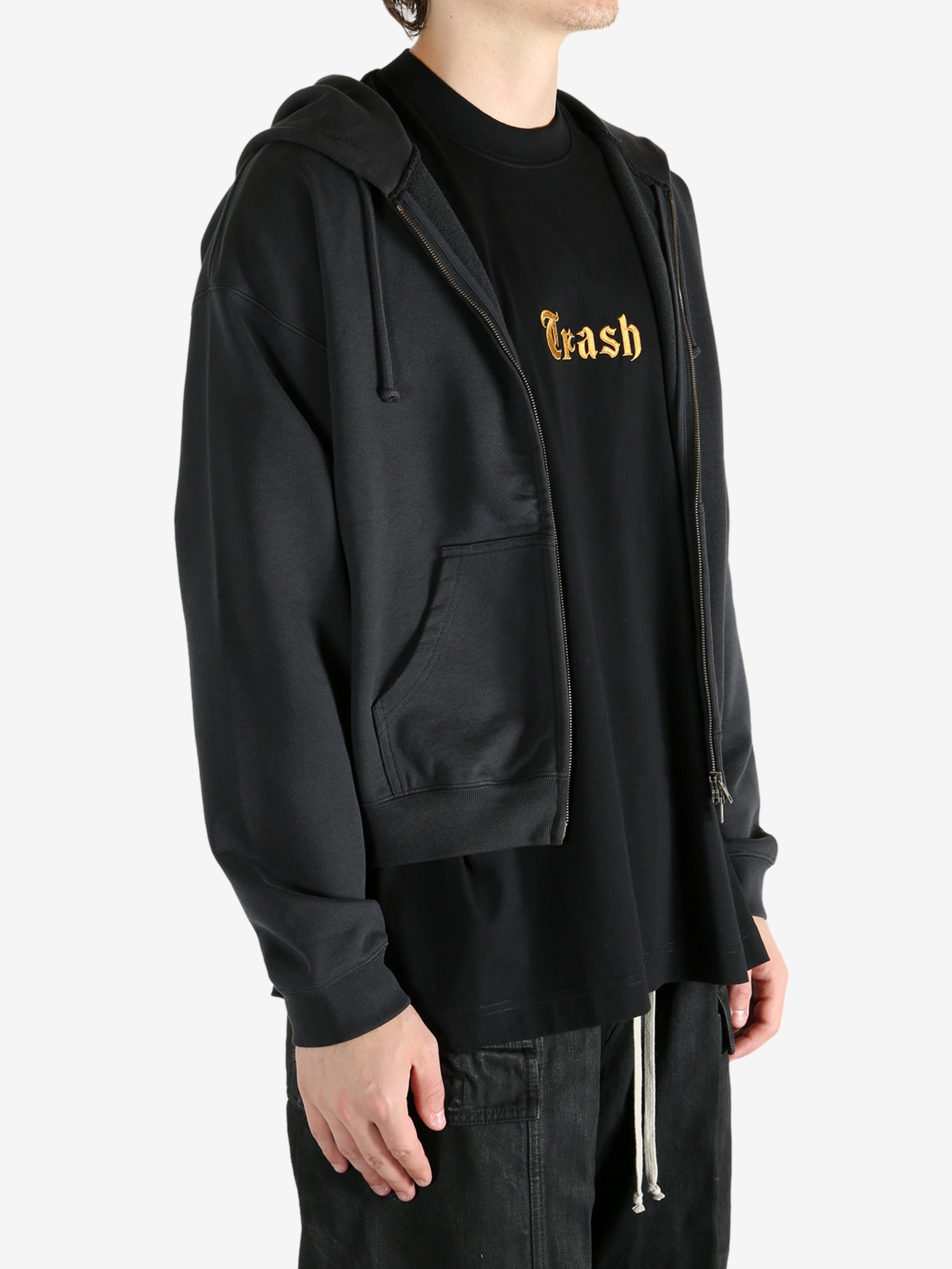Black hoodie worn by a person, showing the hoodie's fit