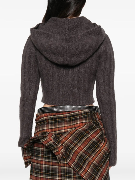 Brown knitwear worn by a person, showing the knitwear fit