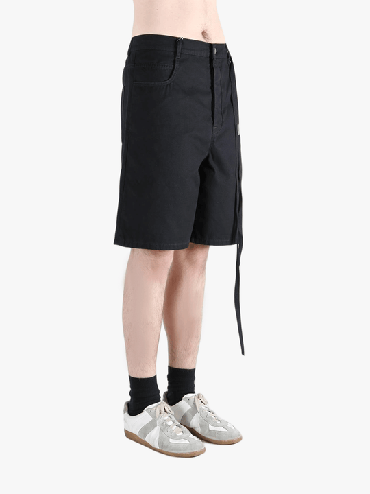 Black short worn by a person, showing the cotton fit