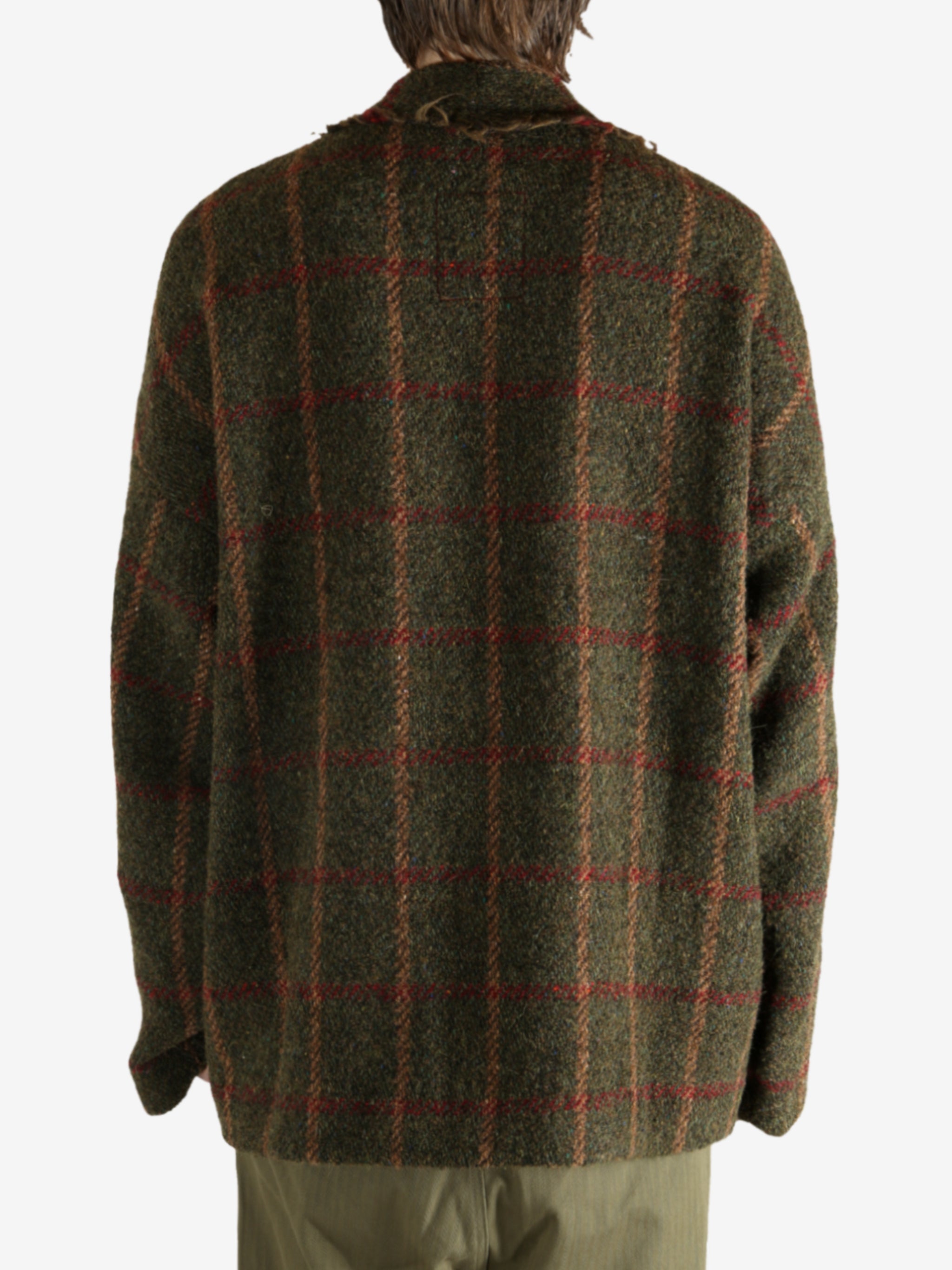 Green jacket worn by a person, showing the jacket's fit