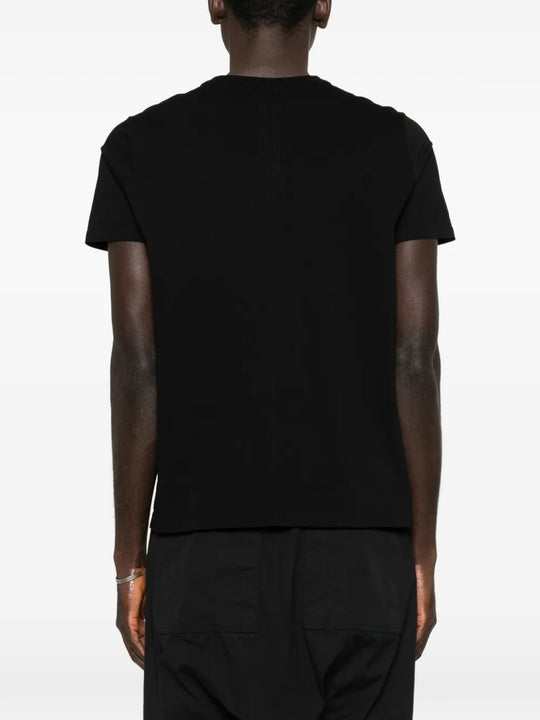 Black t-shirts worn by a person, showing the t-shirts fit