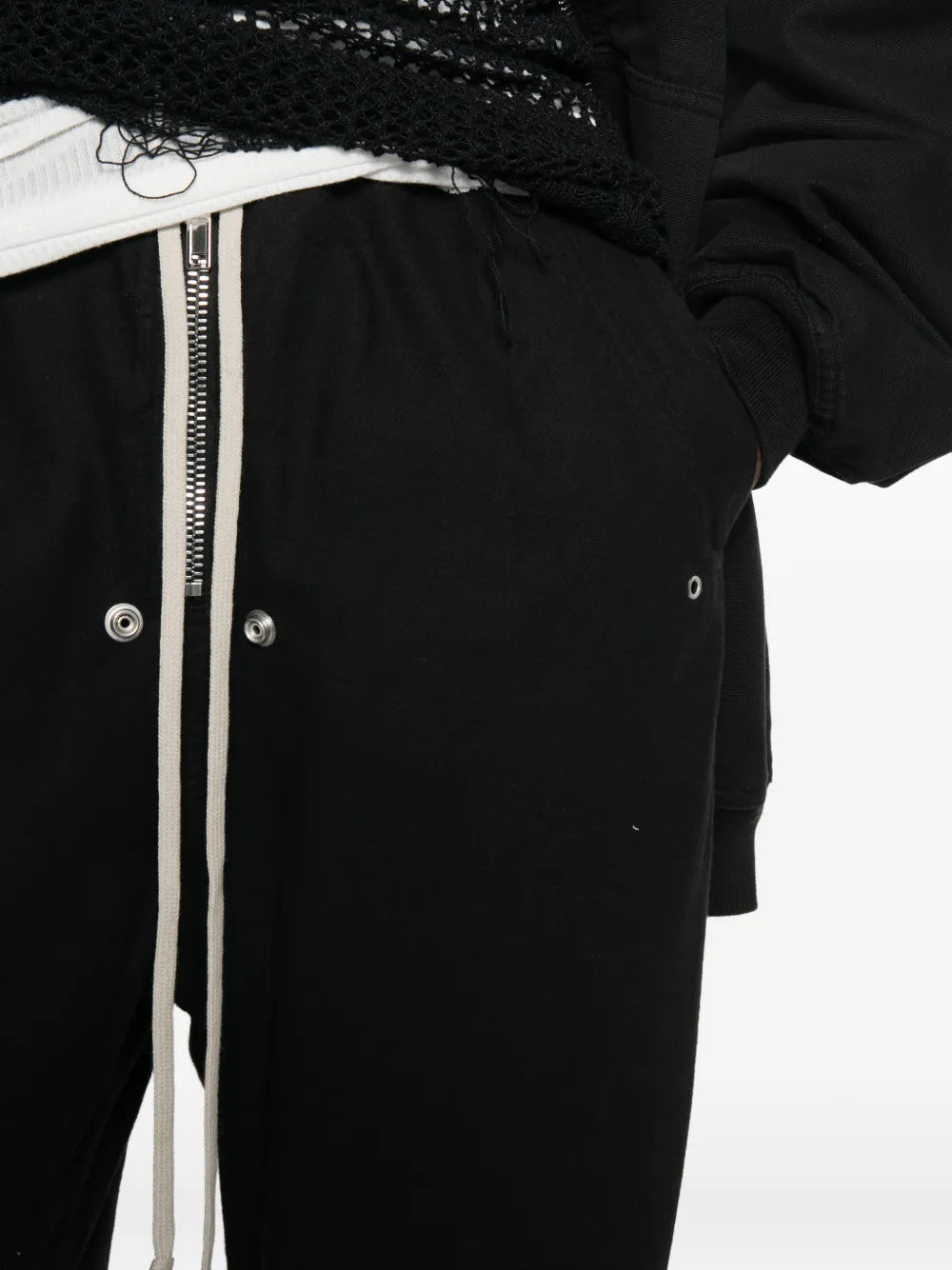 Black pants worn by a person, showing the pants fit