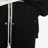 Black pants worn by a person, showing the pants fit