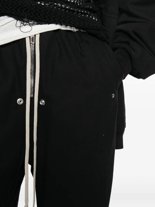 Black pants worn by a person, showing the pants fit