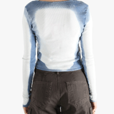 White long sleeve worn by a person, showing the tight fit.