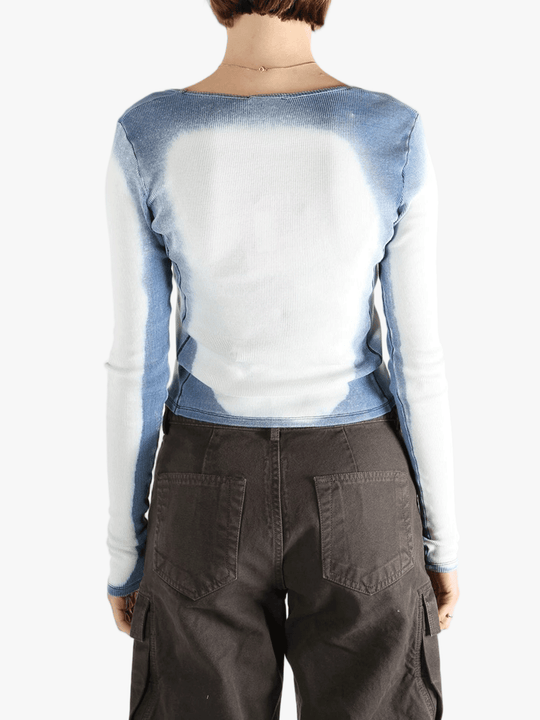 White long sleeve worn by a person, showing the tight fit.