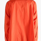 Red shirt worn by a person, showing the shirt's fit