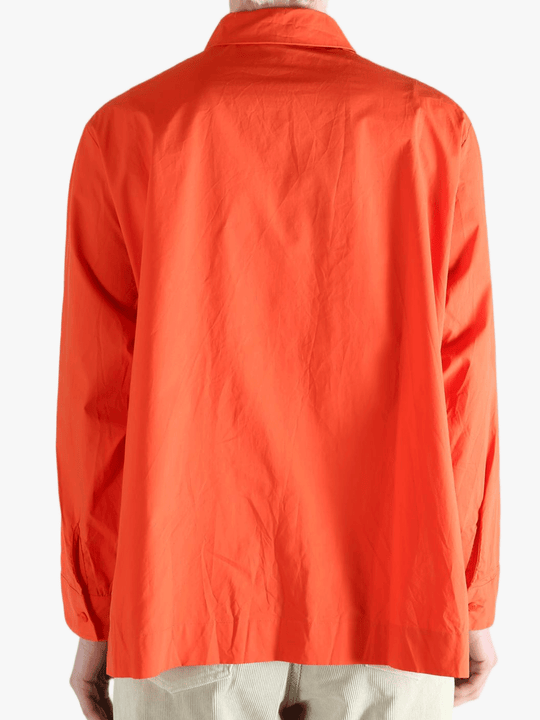 Red shirt worn by a person, showing the shirt's fit