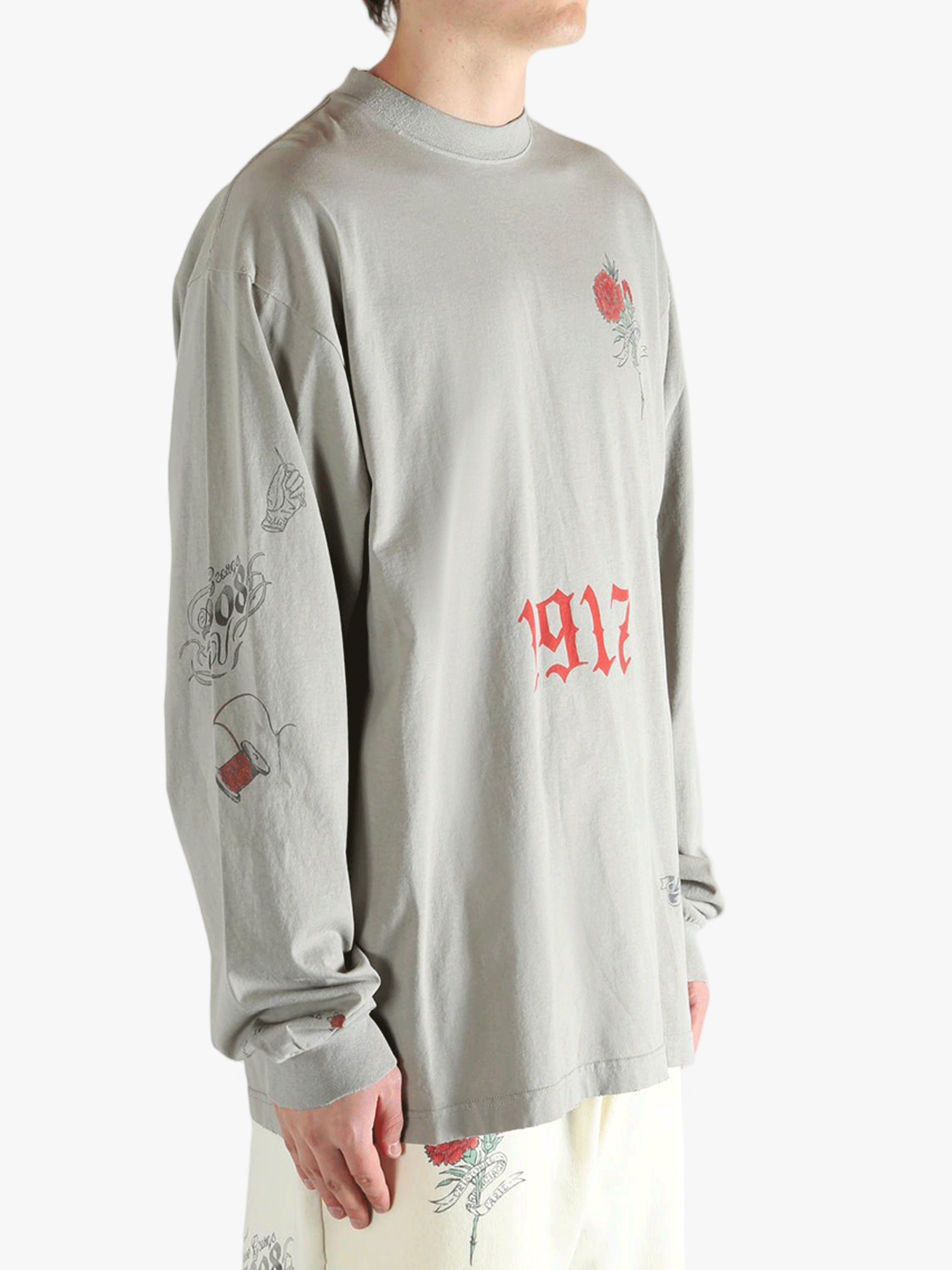 Grey tops worn by a person, showing the top fit