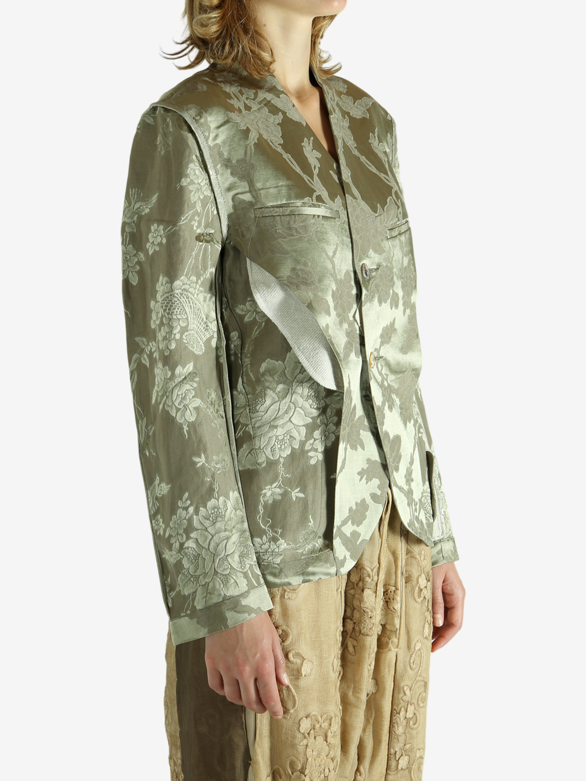 Green jacket worn by a person, showing the jacket fit