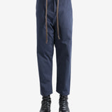 Navy pants worn by a person, showing the pants's fit