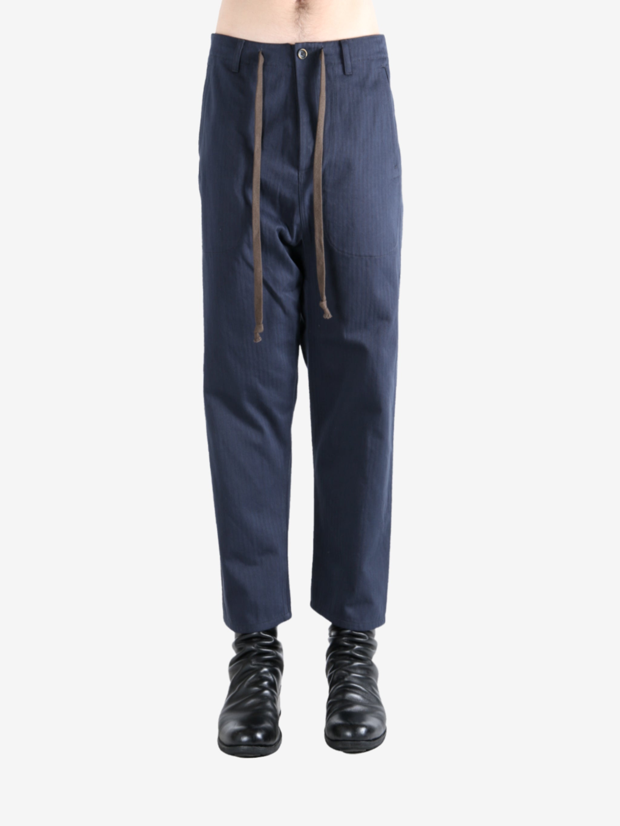 Navy pants worn by a person, showing the pants's fit