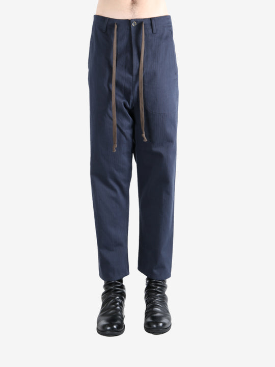 Navy pants worn by a person, showing the pants's fit