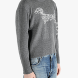 Grey knitwear worn by a person, showing the knitwear fit