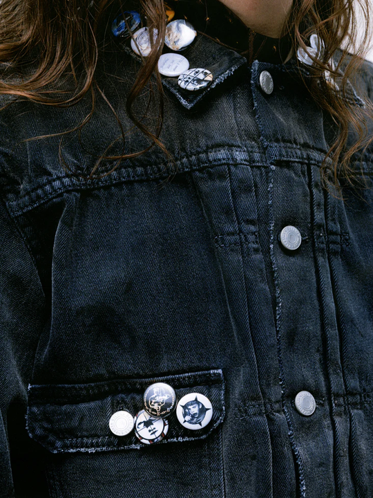 Close up of the grey jacket, showing texture of the cotton fabric