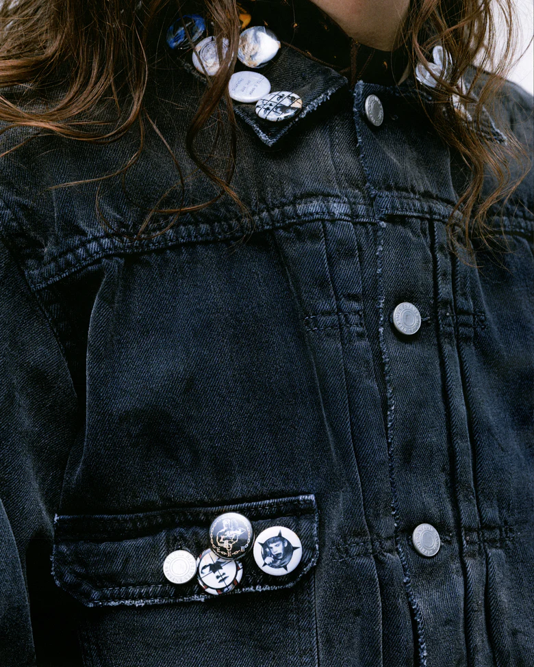 Close up of the grey jacket, showing texture of the cotton fabric