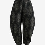 Black pants worn by a person, showing the pants's fit