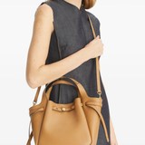 brown bags worn by a person, showing the calf Leather fit