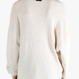 White sweater worn by a person, showing the sweater's fit