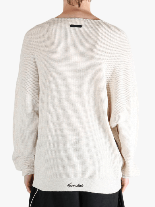White sweater worn by a person, showing the sweater's fit