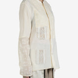 White shirt worn by a person, showing the shirt's fit