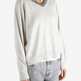 White knitwear worn by a person, showing the knitwear fit