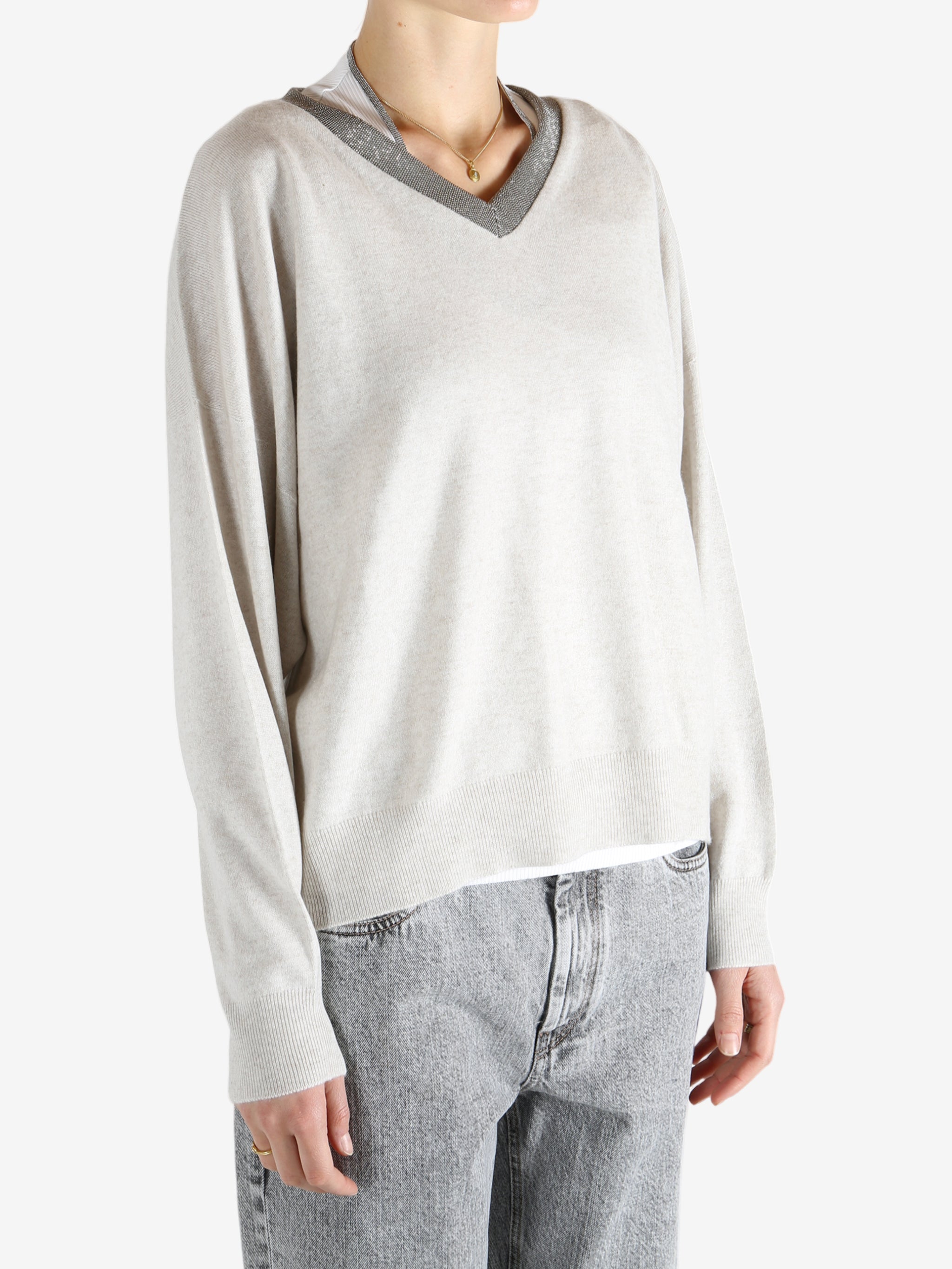 White knitwear worn by a person, showing the knitwear fit