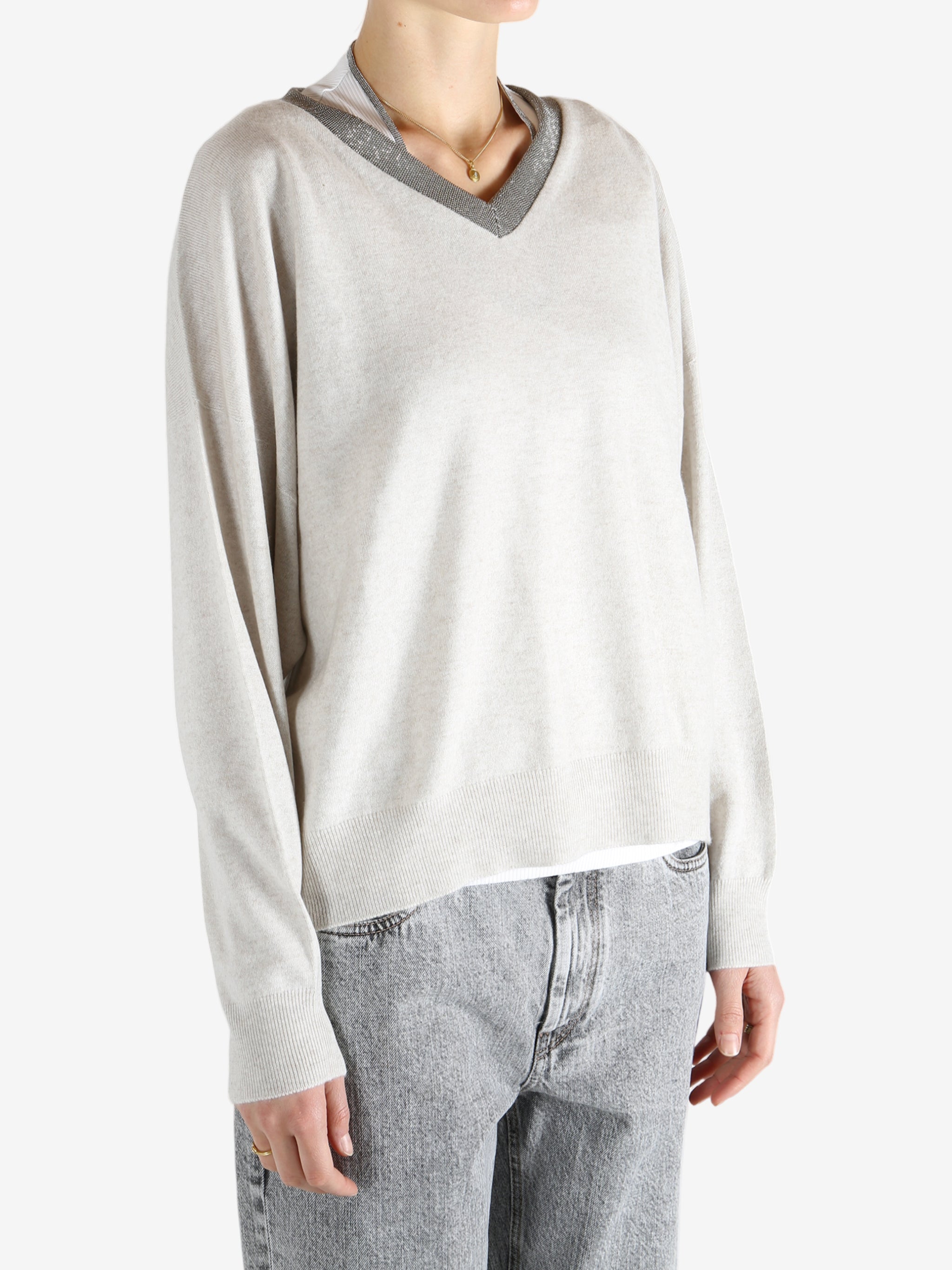 White knitwear worn by a person, showing the knitwear fit