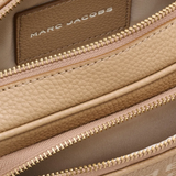 Close up of the brown bag, showing texture of the leather fabric