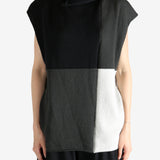 Black top worn by a person, showing the top fit